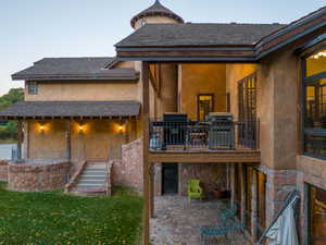 Back of property with a patio area and a lawn