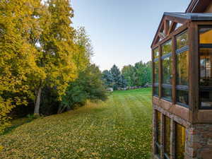 View of yard featuring a sunroom