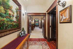 Hall with dark hardwood / wood-style flooring