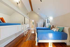 Bedroom featuring lofted ceiling with beams and wood-type flooring