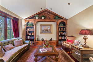 Sitting room featuring hardwood / wood-style flooring and vaulted ceiling