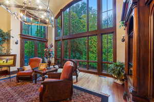 Sunroom with plenty of natural light and a chandelier