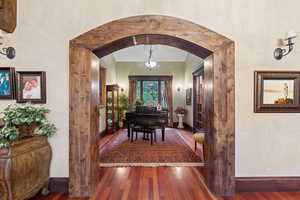 Hallway with dark hardwood / wood-style flooring