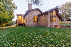 Back of house featuring a lawn