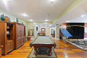 Recreation room featuring light hardwood / wood-style flooring, billiards, and a textured ceiling