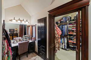 Bathroom featuring vaulted ceiling and a textured ceiling