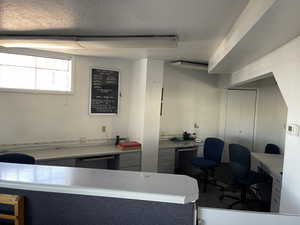 Office space featuring a textured ceiling