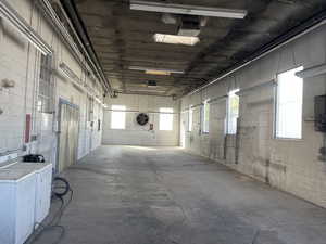 Misc room with washer and clothes dryer and concrete flooring