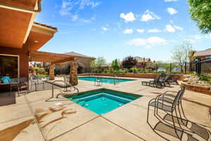 View of pool featuring a pergola, a hot tub, and a patio