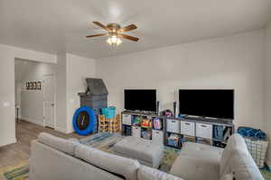 Living room with ceiling fan and light wood-type flooring