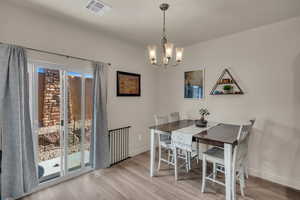 Dining area featuring a chandelier and light hardwood / wood-style floors