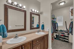 Bathroom featuring a textured ceiling and vanity