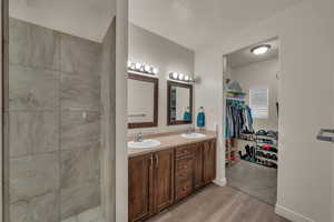 Bathroom featuring a textured ceiling, hardwood / wood-style flooring, and vanity