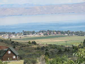 Birds eye view of property featuring a water and mountain view