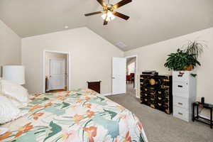 Carpeted bedroom featuring ceiling fan and lofted ceiling