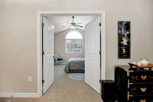 Bedroom with lofted ceiling, light colored carpet, and ceiling fan