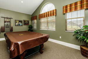 Clubhouse Rec room with dark colored carpet, vaulted ceiling, and pool table