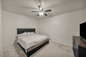 Carpeted bedroom with ceiling fan