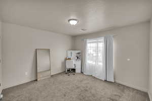 Unfurnished office with light colored carpet