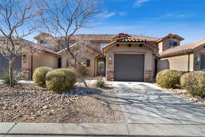 Mediterranean / spanish-style home featuring a garage