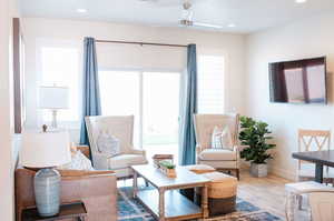 Living room with ceiling fan and wood-type flooring