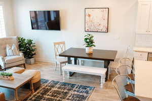 Dining space with light hardwood / wood-style floors