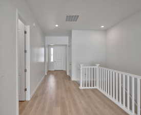 Hallway featuring light hardwood / wood-style flooring