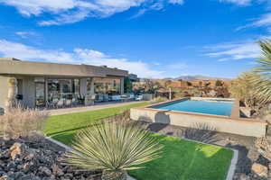 View of pool featuring a patio area and a lawn