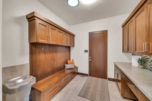 Mudroom with light tile patterned flooring