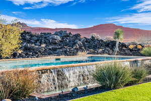 View of swimming pool with a mountain view