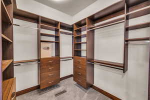 Spacious closet with light colored carpet