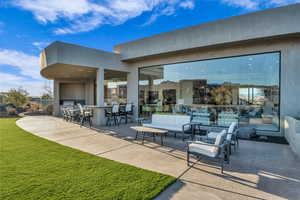 View of patio featuring exterior bar and an outdoor hangout area