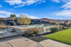 View of pool featuring a mountain view and an in ground hot tub