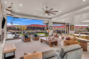 Living room with a large fireplace, a mountain view, and light carpet