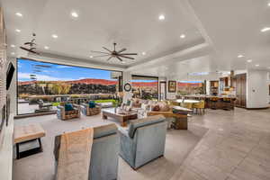 Interior space featuring a bar, ceiling fan, an outdoor living space, and a mountain view