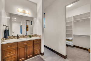 Bathroom with vanity and decorative backsplash