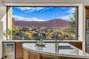 Interior space featuring a mountain view, sink, stainless steel appliances, and beverage cooler