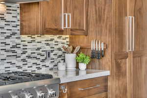 Interior details featuring tasteful backsplash and stove