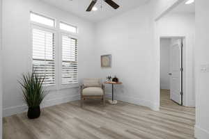 Living area featuring light hardwood / wood-style floors and ceiling fan