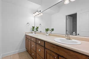 Bathroom with tile patterned flooring and vanity