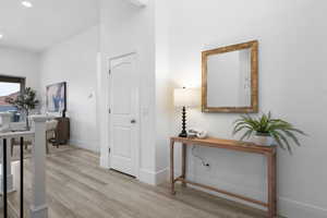 Hall featuring light wood-type flooring