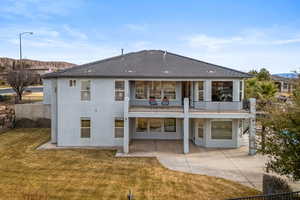 Back of house featuring a yard and a patio