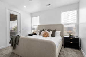 Carpeted bedroom featuring access to outside