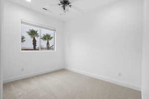 Unfurnished room with ceiling fan and carpet