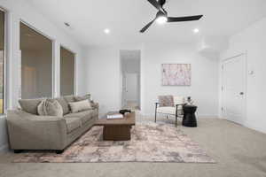 Living room with ceiling fan and carpet flooring