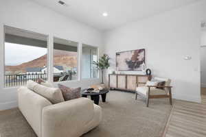 Sitting room with a mountain view and light hardwood / wood-style floors