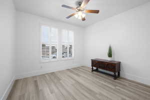 Spare room featuring ceiling fan and light wood-type flooring