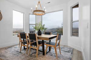 Dining space featuring wood-type flooring and a chandelier