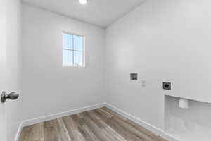 Laundry room featuring hookup for a washing machine, electric dryer hookup, and hardwood / wood-style flooring