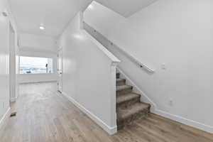 Stairway with hardwood / wood-style floors